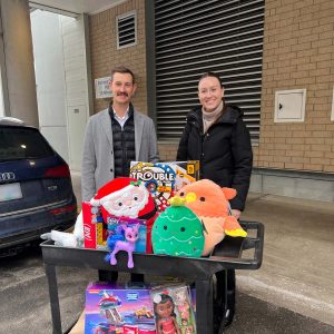 Kelowna Commercial Real Estate Brokers Shelby Kostyshen and Victoria Mitchell with donations for the KGH Foundation from the William Wright Commercial Toy Drive 2023